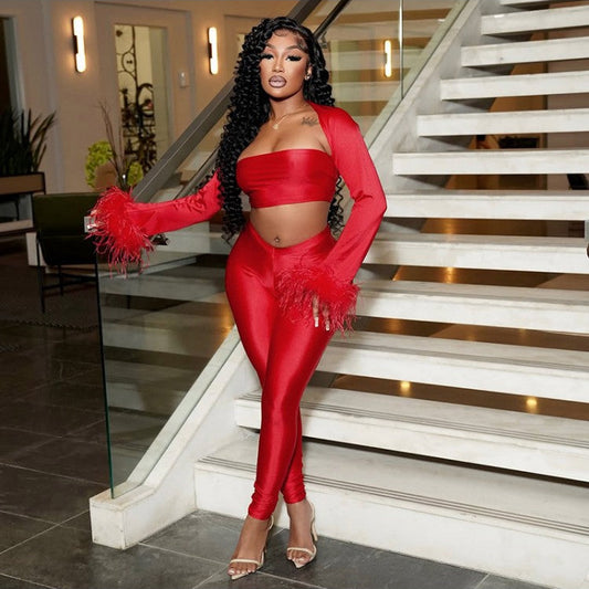 Person in a red outfit standing on a staircase indoors
